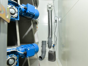 image of the blue engines in the vending machine that turn the stainless steel shelves with the agricultural products